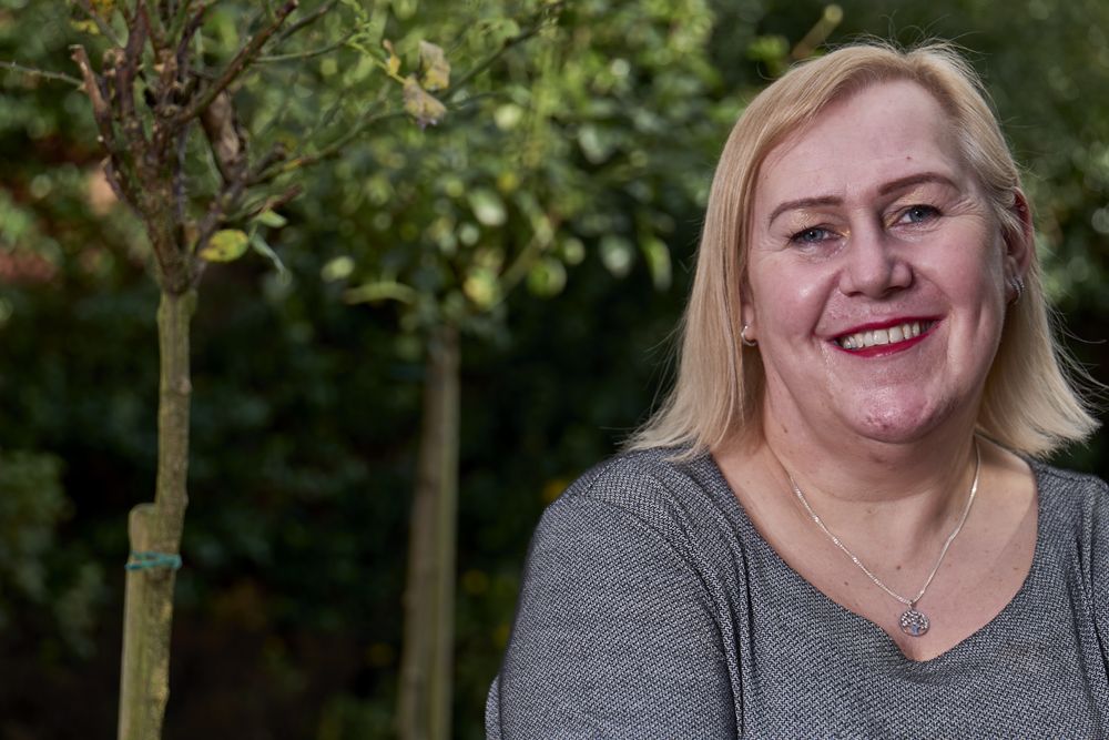 Portrait of happy woman standing in garden