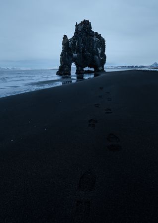 Rocky shoreline of sea in clouds in Iceland