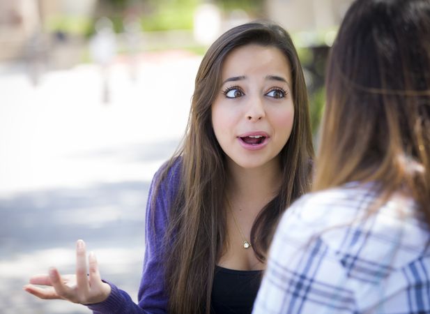 Expressive Woman Sitting and Talking with Friend