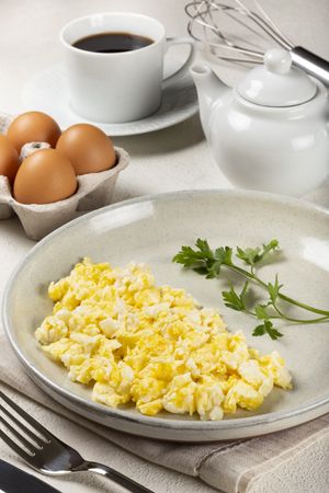 Breakfast with scrambled eggs on the table.