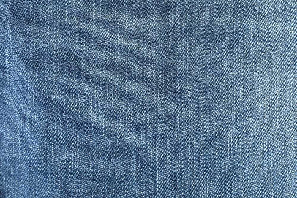 Texture of blue jeans as background, space for text