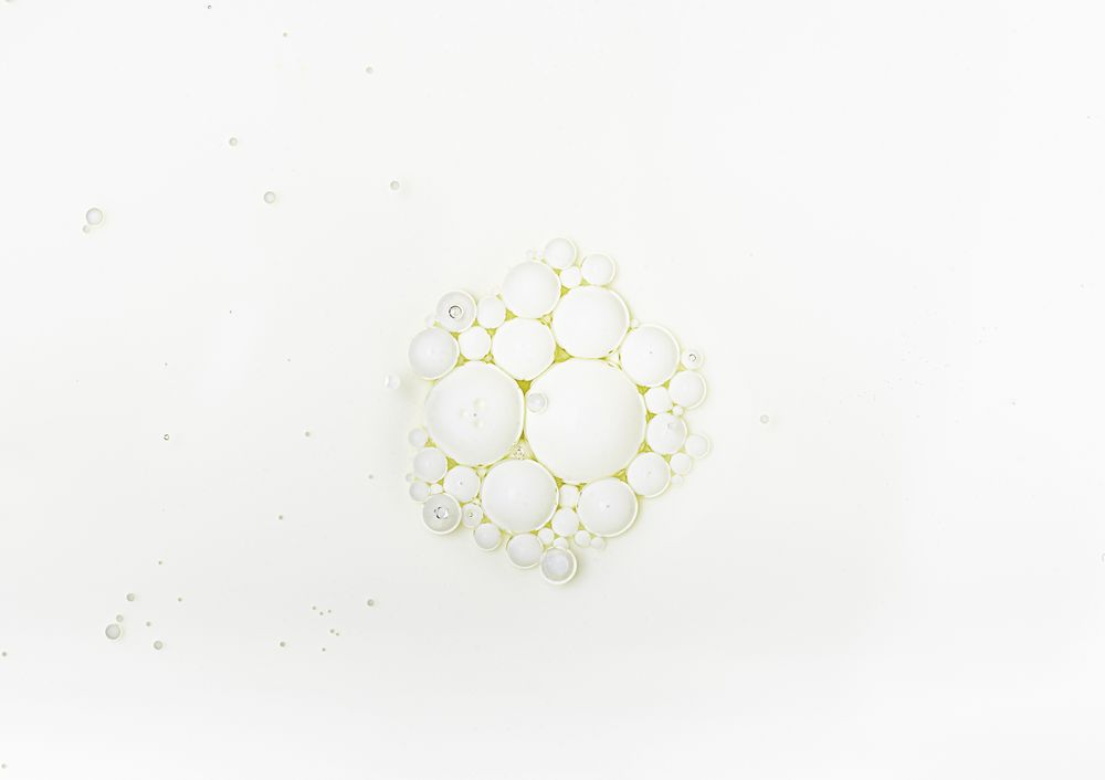 Milk surface with oil bubbles