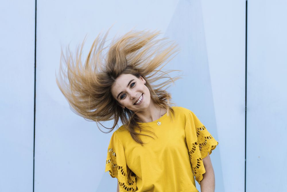 Young woman shaking hair