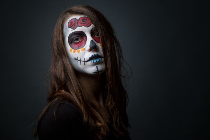 Young woman with creepy face paint