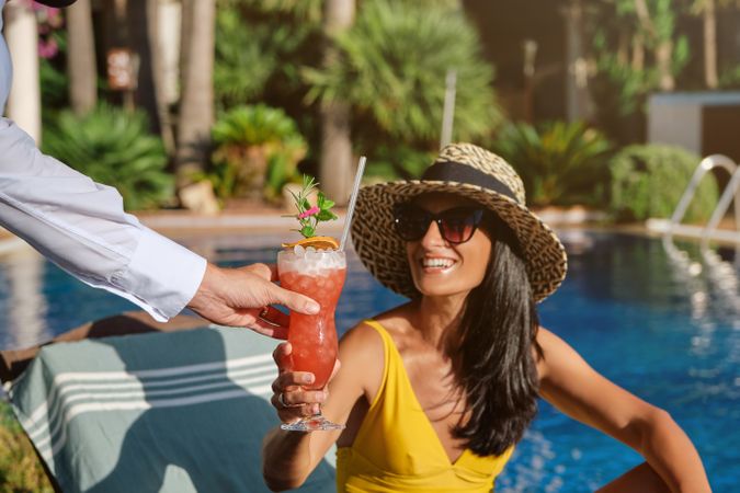 Happy woman getting a cocktail in resort