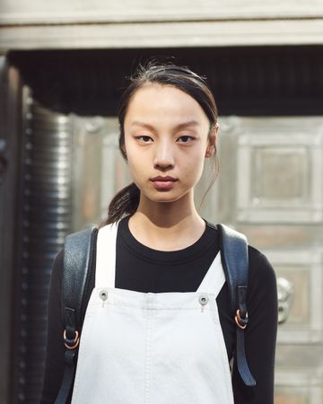 London, England, United Kingdom - September 15th, 2019: Portrait of young woman in overalls