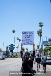 Los Angeles, CA, USA — June 14th, 2020: back view of woman holding protest sign 4Ba7k5