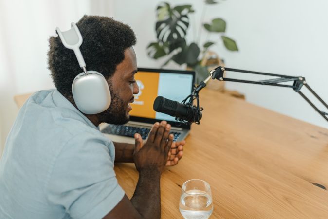 Content Black man recording podcast in studio