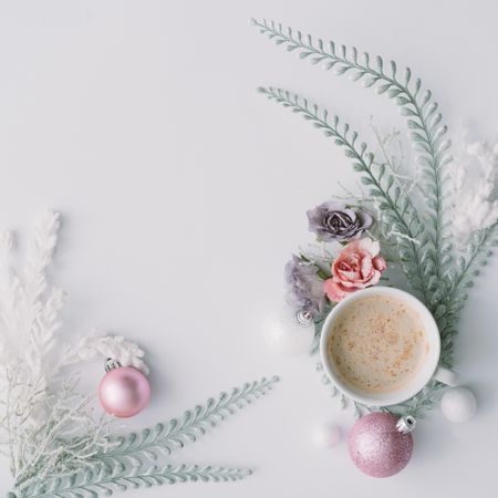 Coffee with flowers, leaves and pink Christmas decoration