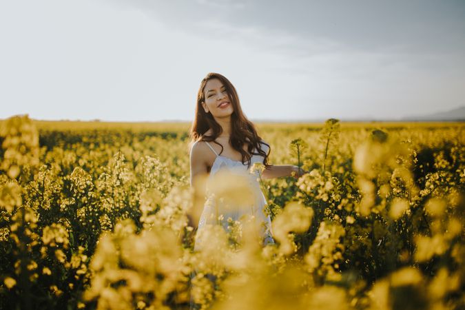 Woman with flowers in field
