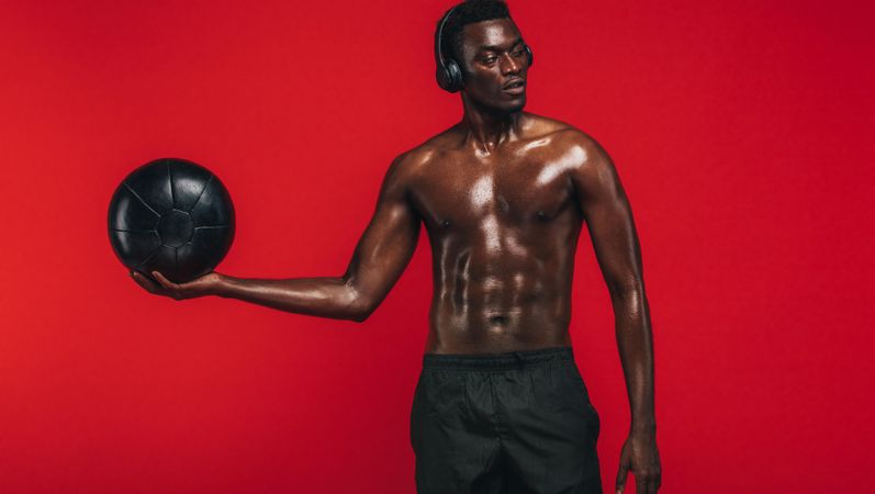 Black man exercising with a fitness ball