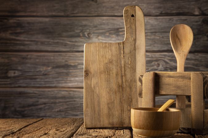 Wooden kitchen utensils on rustic background.
