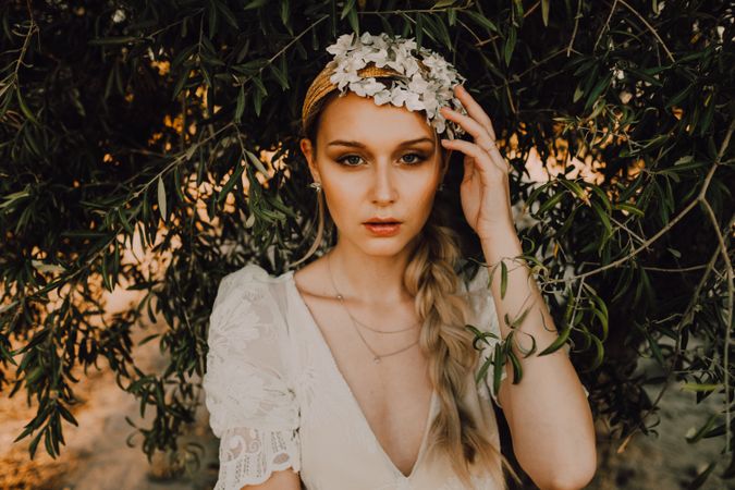 Charming woman in elegant dress near tree