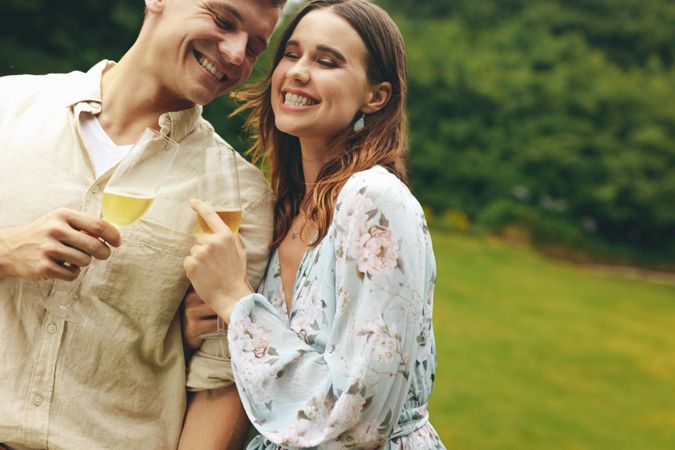 Couple at a park enjoying champagne together