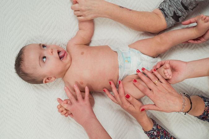 Portrait of cute baby boy with Down syndrome with his family