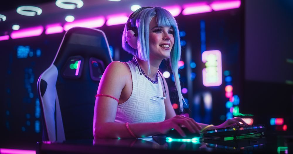 Stylish Streamer or Gamer with Blue Hair Chats with Internet Fans on Computer in Futuristic Cyber Technology Room.