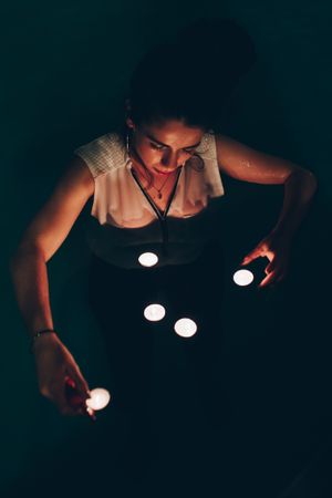 Woman swimming in pool with candles