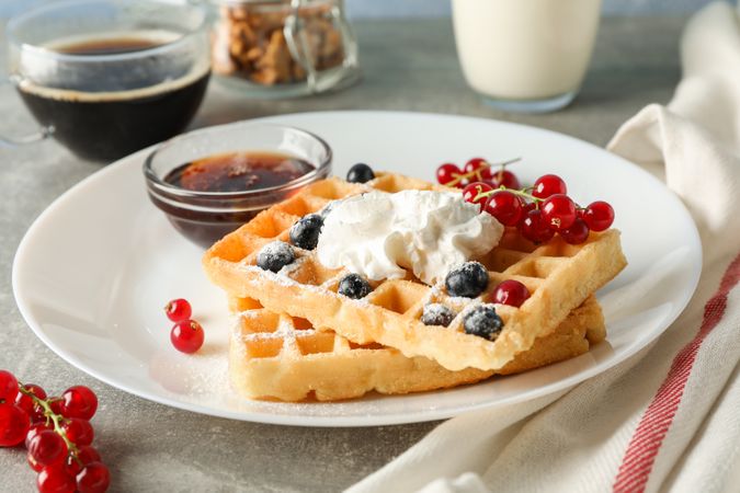 Composition of breakfast with belgian waffles, space for text