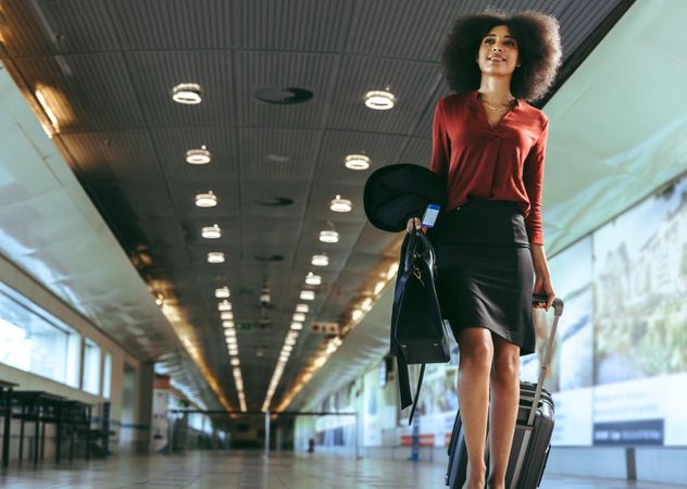Female traveler walking through airport terminal