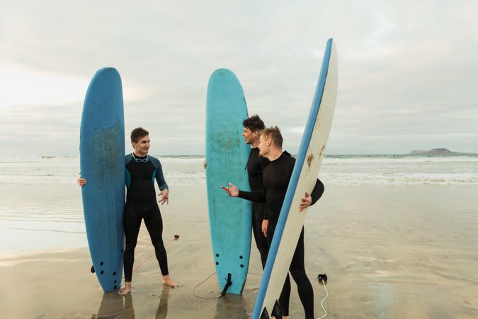 Excited men with surfboards