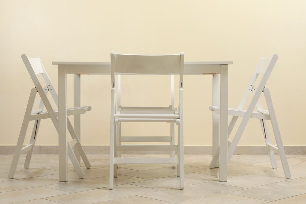 table and folding chairs in kitchen room
