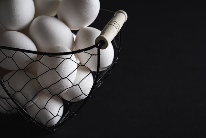 Organic eggs in wire basket close-up