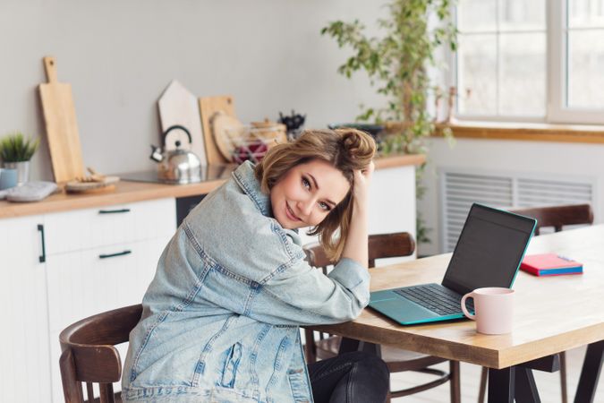 Freelancer Workplace At Kitchen Table With Laptop