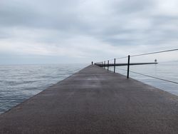 One person on railed path to Two Harbors Light House in Two Harbors, Minnesota