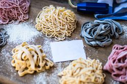 Cooking concept with italian homemade pasta on wooden board