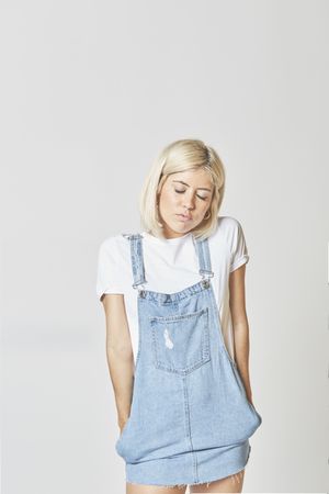 Trendy blonde female in denim sundress