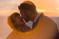 Young people kissing in sunset light on ship