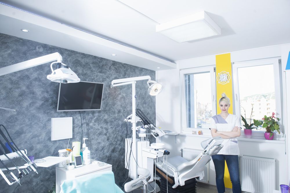 Female dentist with her arms crossed in her office