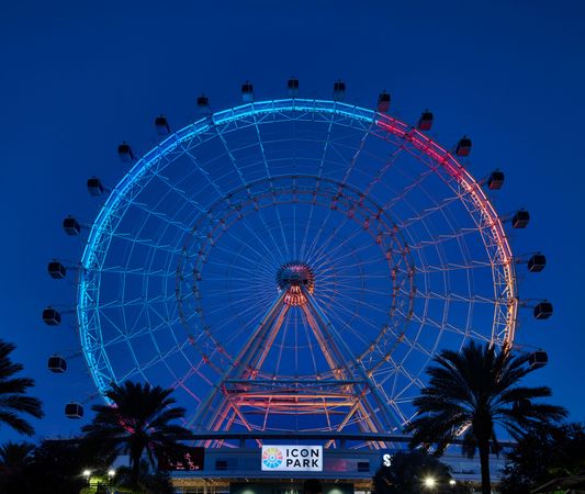 Large illuminated Ferris wheel at dusk in Orlando