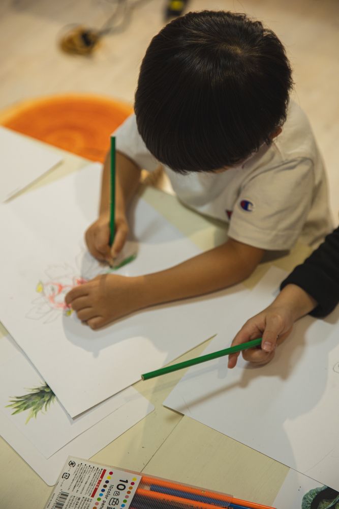 Top view of child drawing on paper