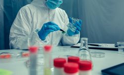 Scientist with protection suit doing research in the laboratory