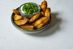 Chicken wings with dip and potato wedges on light