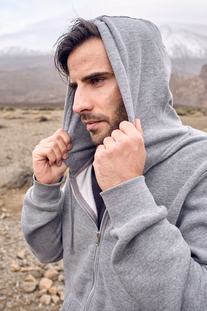 man in hoodie in mountains