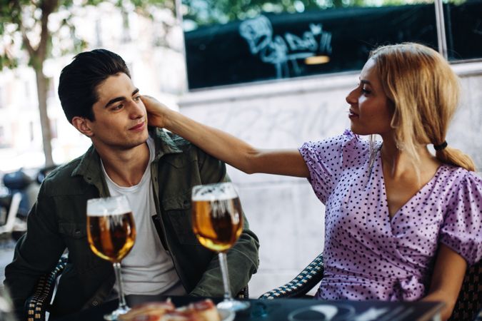 Happy young couple drinking beverages outdoors