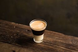 Cups of tasty hot coffee drink on wooden table