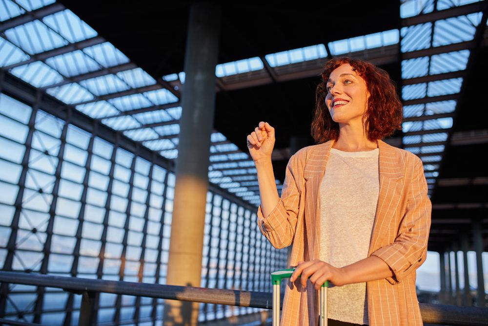 Smiling attractive young female at station