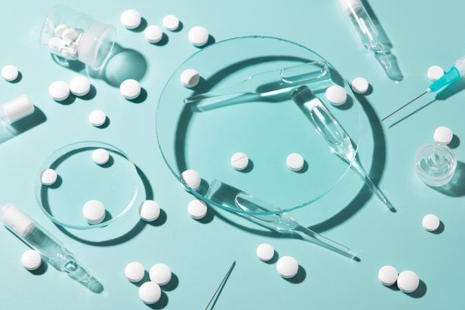 Variety of pharmaceutical items on green background