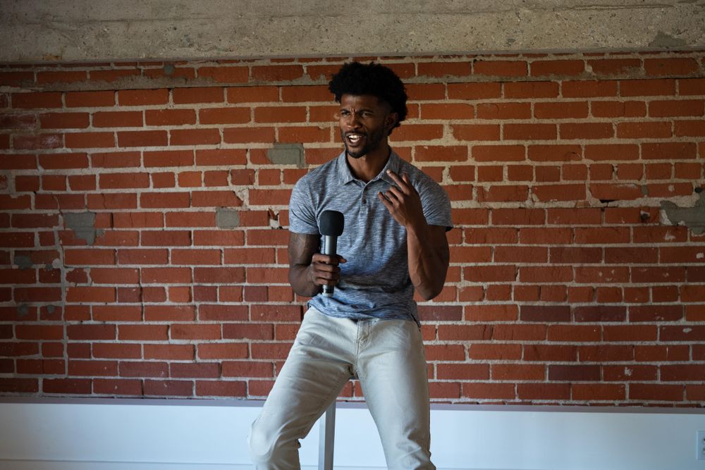 Man passionately public speaking with microphone