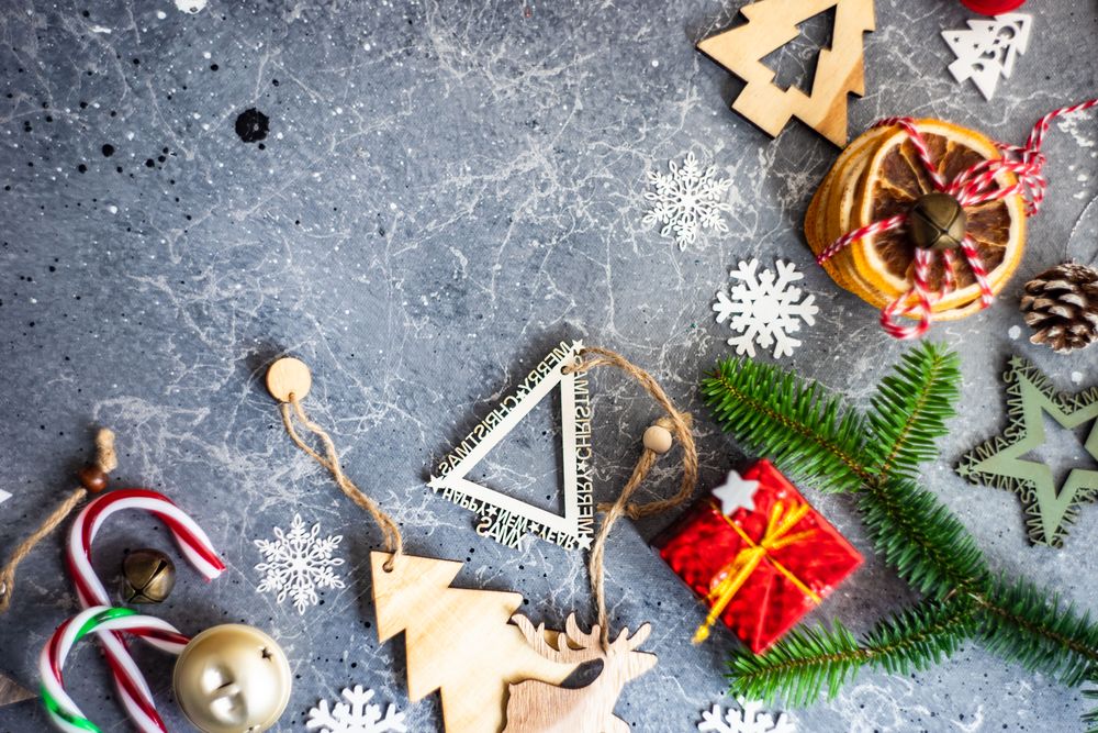 Christmas ornaments and fir scattered on marble table