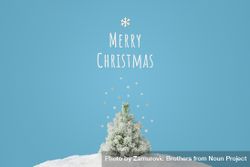 Snowy Christmas tree on blue background, with “Merry Christmas” text 5RdBrb
