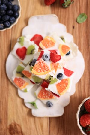 Frozen Yogurt Bark with Berries over Wooden Table