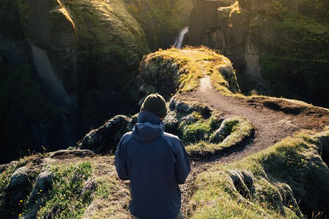 Back of man walking down trail