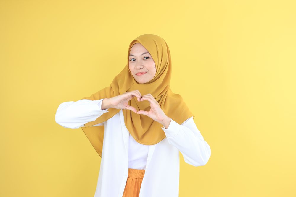 Young Female Making Love Sign with Her Hand