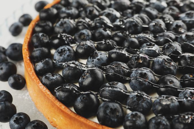 Tasty blueberry pie with syrup, close up