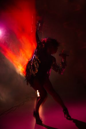 Stylish woman singing on stage