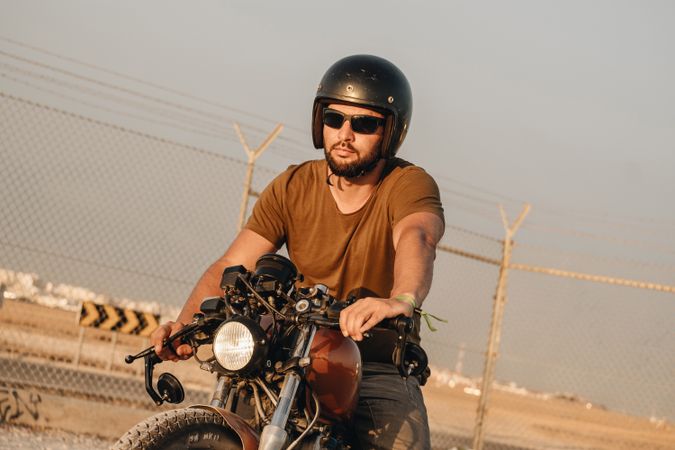 Strong man driving motorcycle
